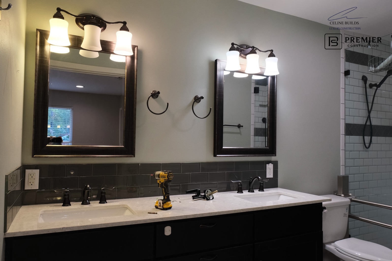 Bathroom before renovation - dark fixtures, dated tile, dim lighting
