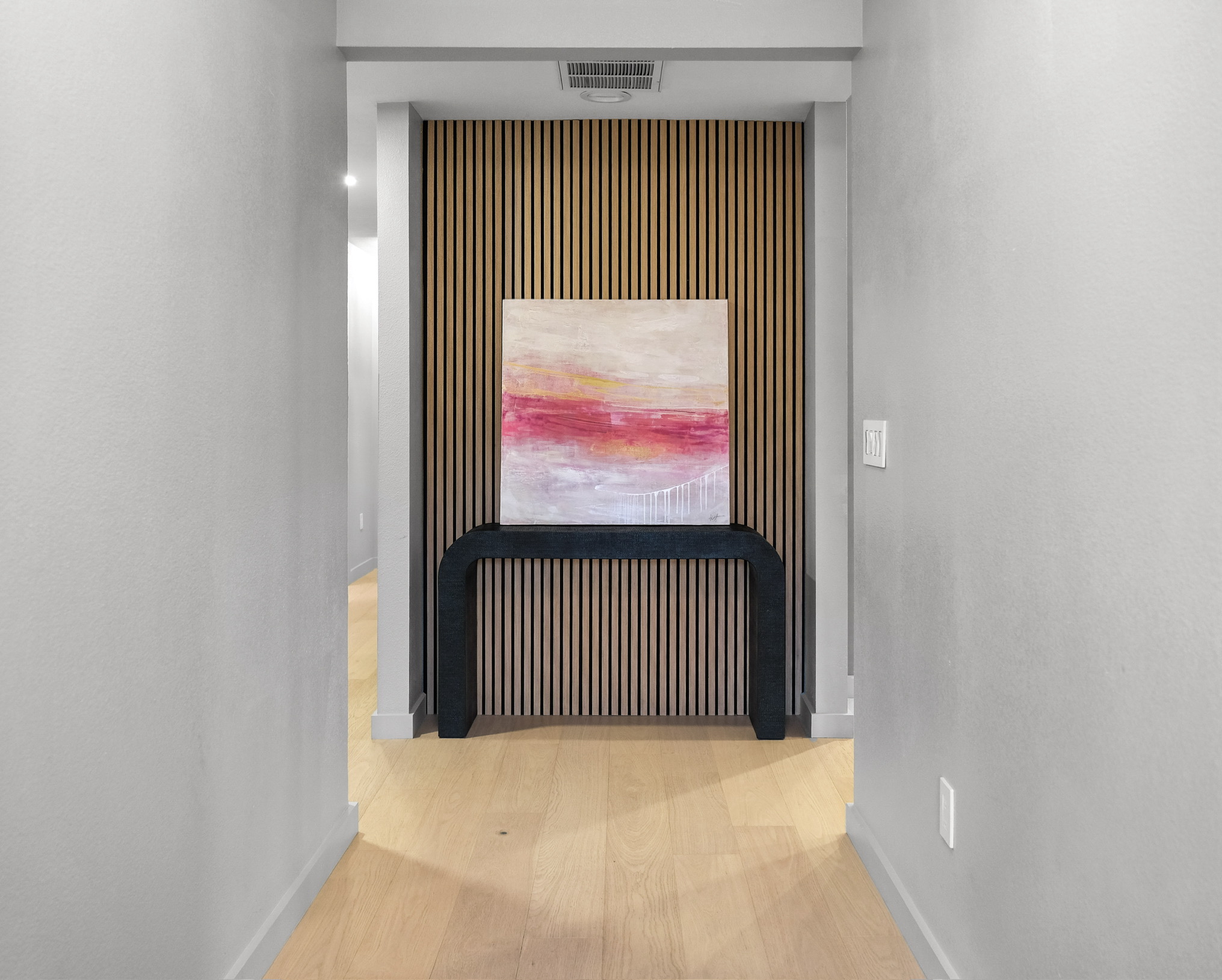 Modern hallway with oak slat accent wall